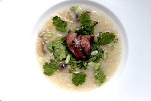 Congee with herbs and sliced steak